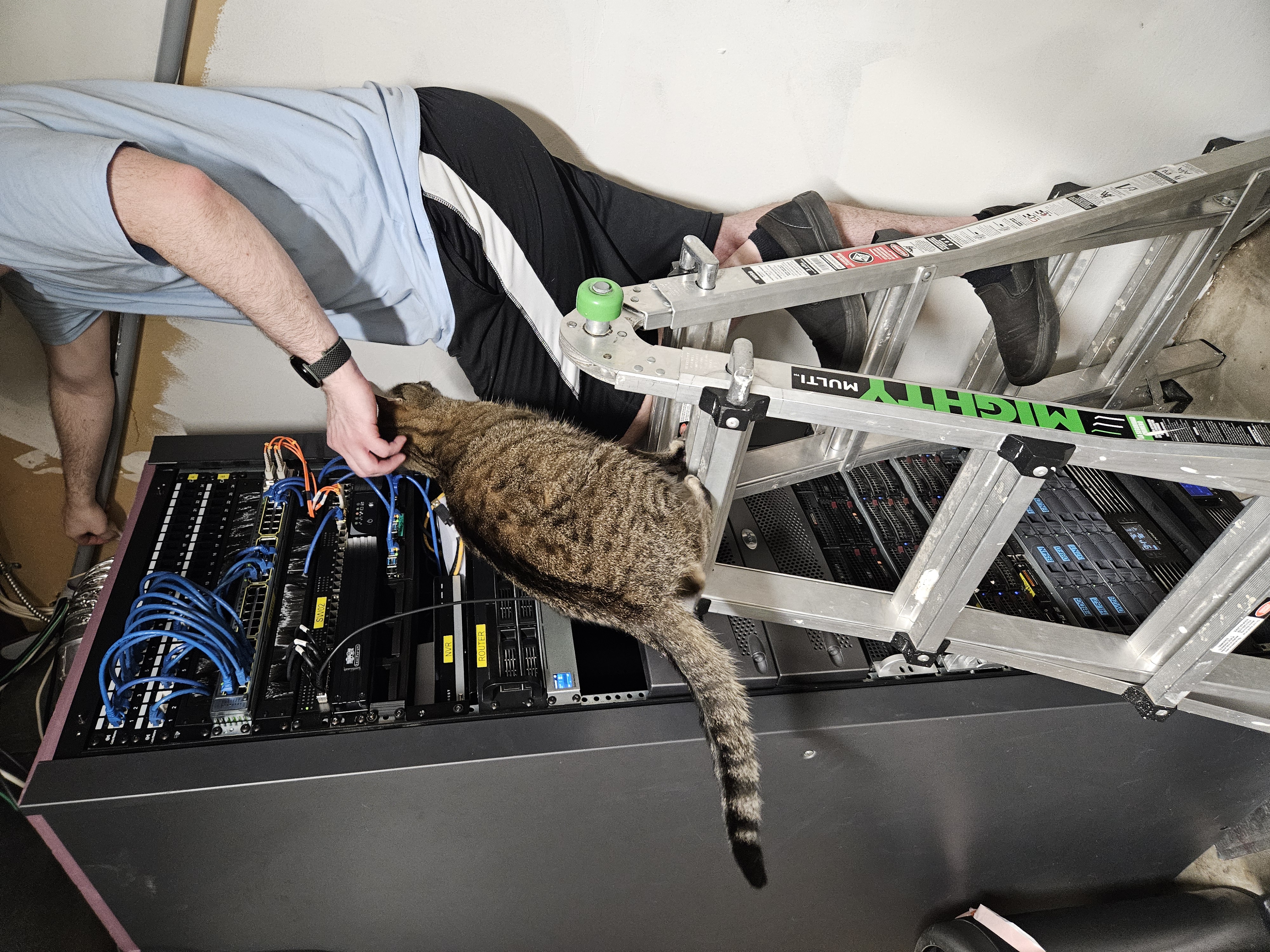 Climbing the ladder while her dad works on the server rack